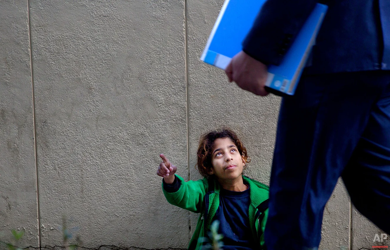  In this Wednesday, March 16, 2016 photo, a Syrian refugee girl begs for money on a sidewalk outside a hospital in Beirut. It is one of the most visible signs of the refugee crisis that has put an immense strain on neighboring countries and destabili