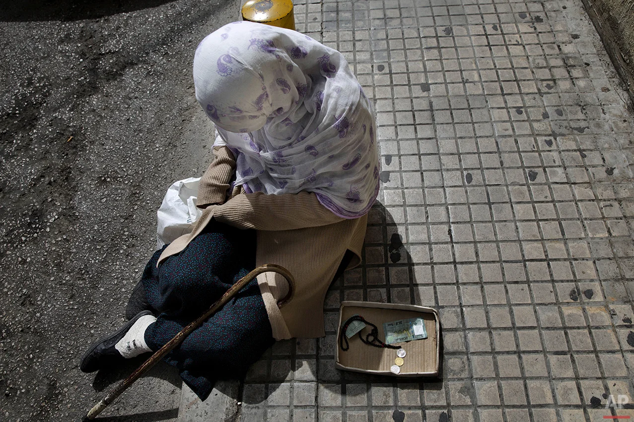  In this Friday, March 25, 2016 photo, a Syrian refugee woman, who fled her hometown Aleppo, begs for money on a sidewalk, in Beirut. Lebanon is home to more than 1 million registered Syrian refugees, or nearly a quarter of the country's 4.5 million 