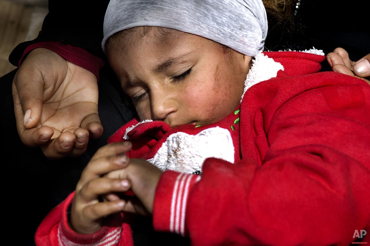 In this Friday, March 25, 2016 photo, a Syrian refugee woman holds her child as she begs for money on a sidewalk, in Beirut. Lebanon is home to more than 1 million registered Syrian refugees, or nearly a quarter of the country's 4.5 million people, 