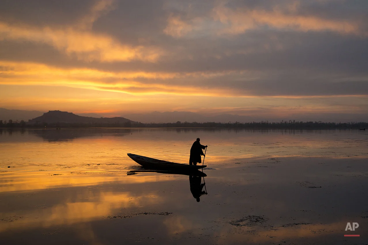  A Kashmiri fisherman rows his Shikara, or traditional boat, during sunset at the Dal Lake in Srinagar, Indian controlled Kashmir, Tuesday, March 29, 2016.  Nestled in the Himalayan mountains and known for its beautiful lakes and saucer-shaped valley