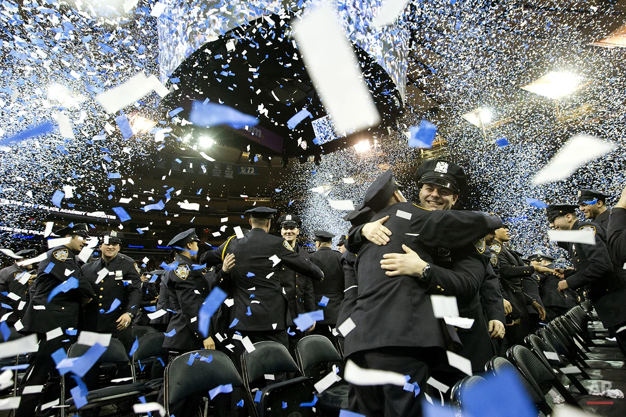  New police officers embrace at the end of the New York City Police Department Police Academy graduation ceremony, Friday, April 1, 2016, at Madison Square Garden in New York. (AP Photo/Mary Altaffer) 