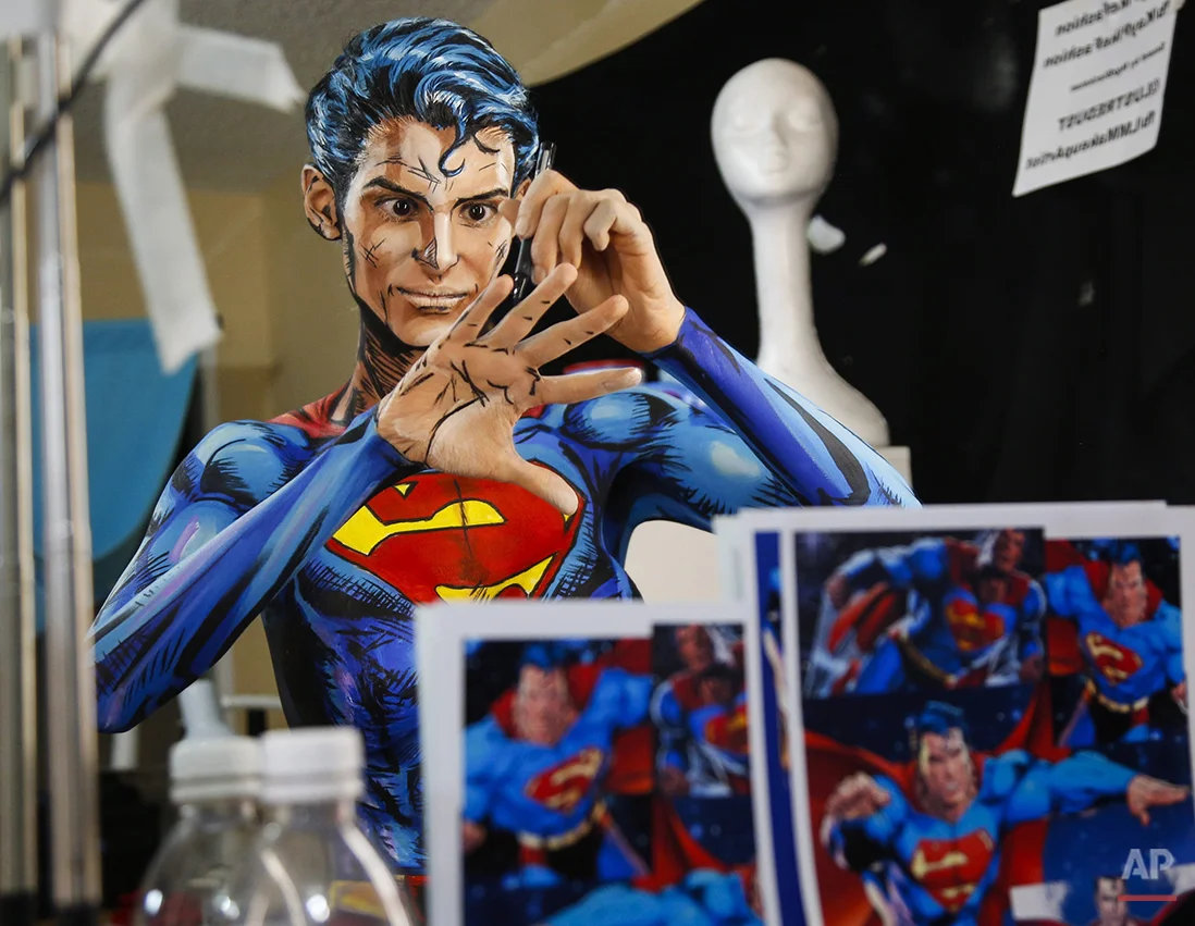  In this March 19, 2016 photo, Kay Pike transforms herself using body paint and latex into Superman while live streaming at her home in Calgary, Alberta. The Canadian artist turns her body into different characters for an Internet audience. (Jeff McI