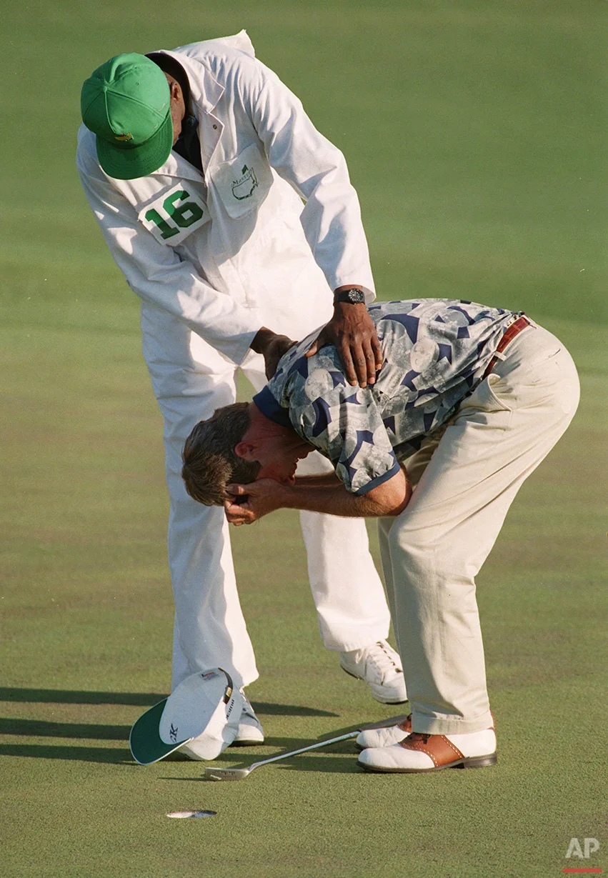 Masters champion Ben Crenshaw is held by caddy Carl Jackson on the 18th as Crenshaw is overcome with emotion as he wins the title at the Augusta National Golf Club in Augusta, Ga. on April 9, 1995. (AP Photo)