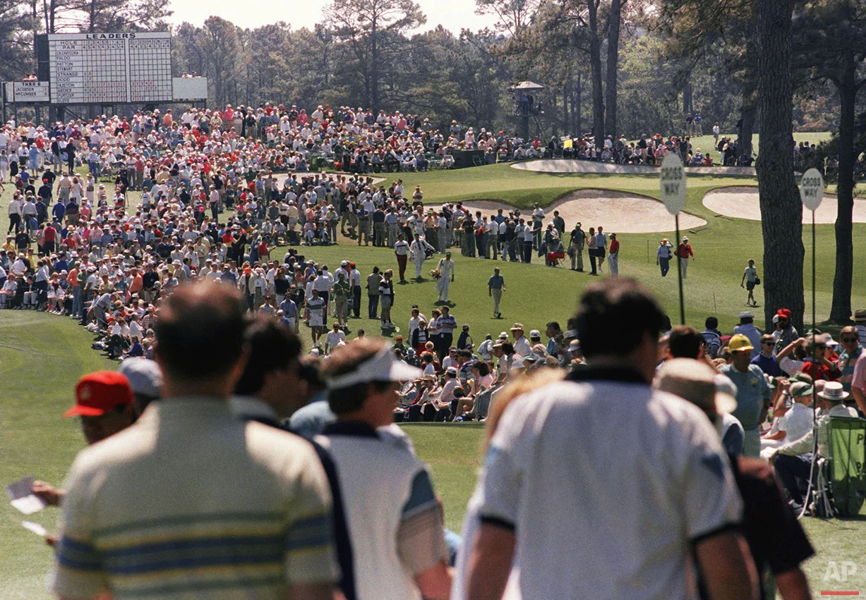 Spectators watch first round Masters play at the Augusta National Golf Club on Thursday, April 5, 1990. (AP Photo/Lou Krasky)