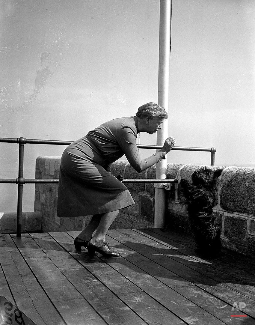 Fala, pet Scottie Terrier of President Roosevelt, goes through his bag of tricks for first lady Eleanor Roosevelt on the terrace of the Citadel, historic fortress of Quebec City, Canada, Sept. 13, 1944. The Roosevelts and British Prime Minister Winston Churchill are in Canada for a military conference. (AP Photo/Murray Becker)