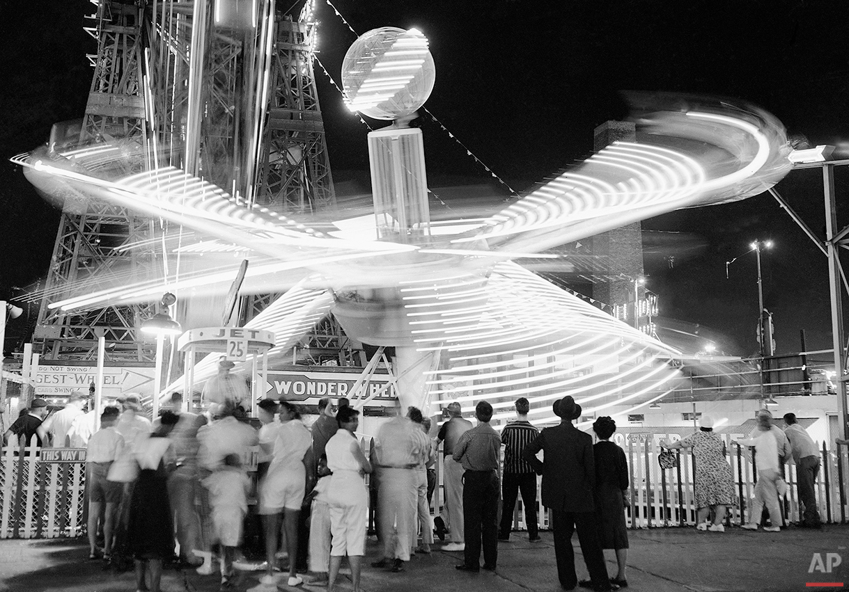  Some of the rides at Coney Island amusement park in New York on August 14, 1959, lose their identity in a whirl of lights as they carry fun-seekers around and around. (AP Photo/Ruben Goldberg) 