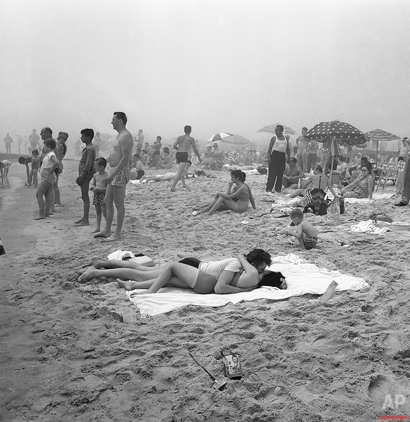  A summer romance blossoms on the beach at Coney Island, New York, July 27, 1961. (AP Photo/John Lindsay) 