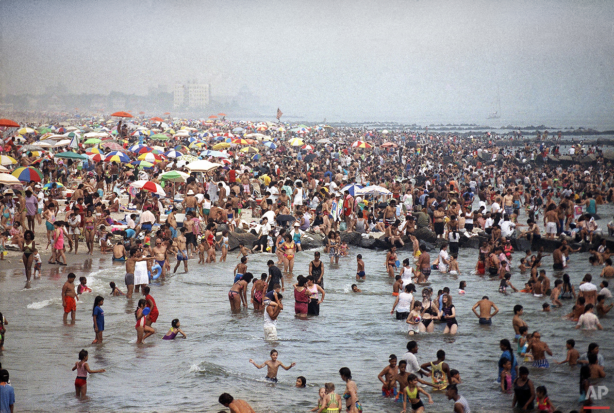  Crowds of people swarm to the beach at Coney Island in Brooklyn on July 21, 1991 in an effort to find relief from temperatures that swarmed over the 100-degree mark in New York City. (AP Photo/Mike Alexander) 