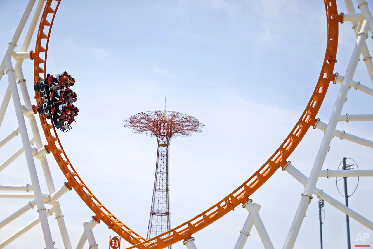 Visitors to Coney Island ride the Thunderbolt, Friday, July 3, 2015, in the Brooklyn borough of New York. (AP Photo/Mary Altaffer)