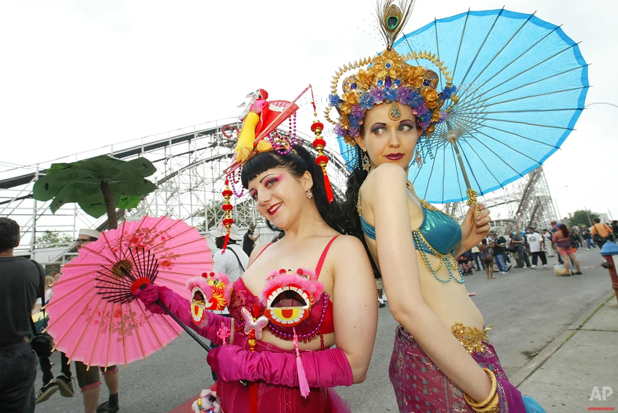 Kate Higgins, left, and Jennie Fiske, dressed as goddesses of the sea, pose at the 22nd Annual Mermaid Parade in the Coney Island section of New York Saturday, June 26, 2004. (AP Photo/Joe Kohen)
