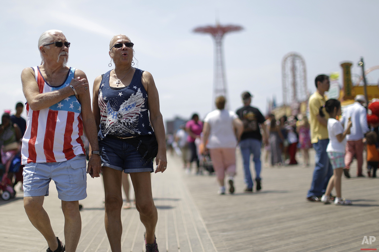  Don, left, and Angela Boerem, of Queens, take a stroll on the Coney Island boardwalk, Friday, July 3, 2015, in the Brooklyn borough of New York. (AP Photo/Mary Altaffer) 