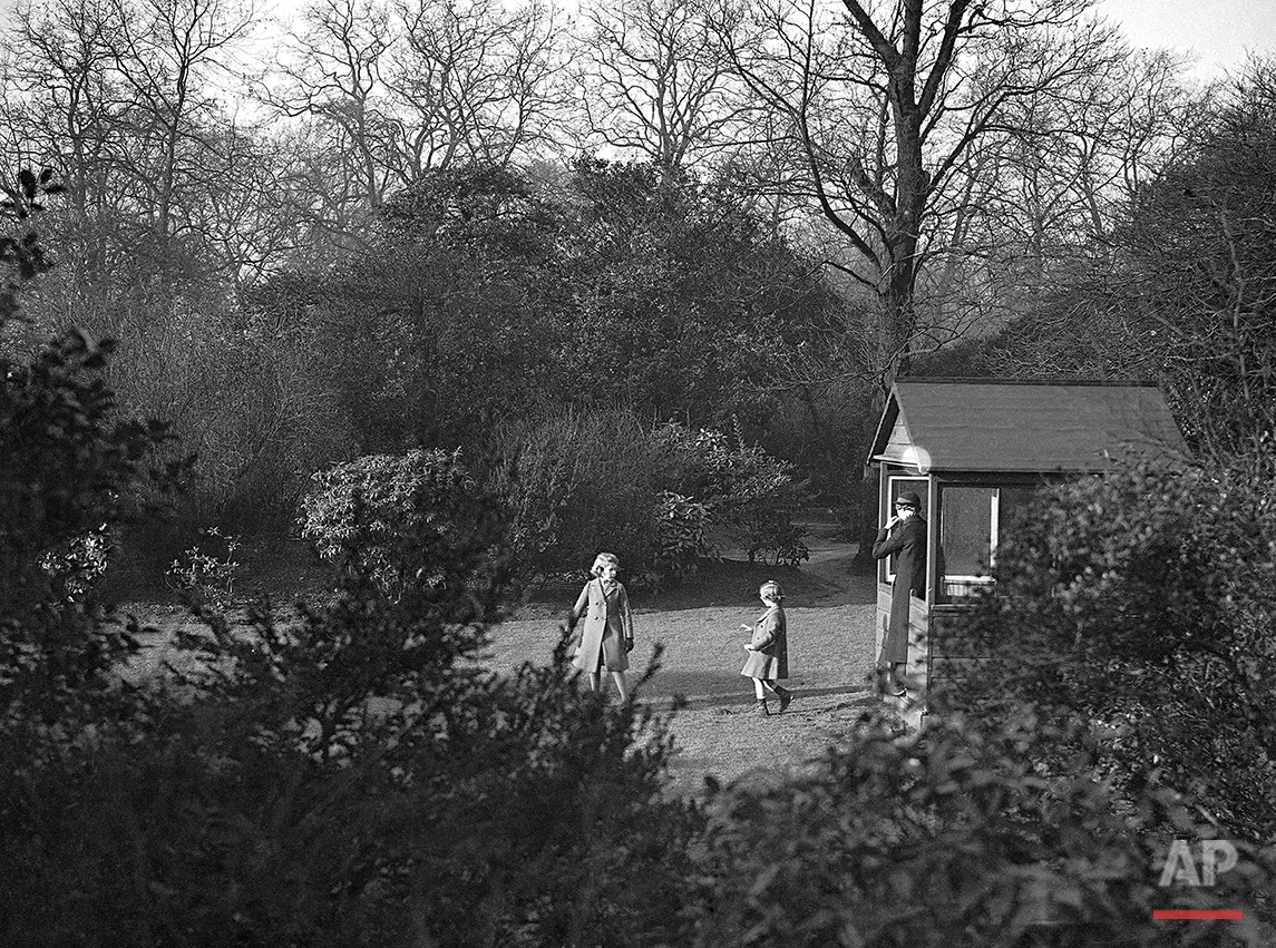 Princess Elizabeth, left, and Princess Margaret Rose playing in the garden of No. 145 Piccadilly, London, in the warm December sun, on Dec. 19, 1936. (AP Photo)