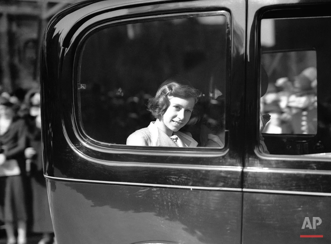 Princess Elizabeth attended the Albert Hall in London, United Kingdom for the national festival of the schools’ musical festivals of England (non-competitive). Boys and girls in a choir of 1,000 voices from all parts of the country sang. The choir functioned with the London Symphony Orchestra, under the direction of Dr. Geoffrey Shaw and Mr. Cyril Winn. In this image Princess Elizabeth is being driven away from the Albert Hall in London, United Kingdom on May 6, 1938 after attending the festival. (AP Photo/Jim Pringle)