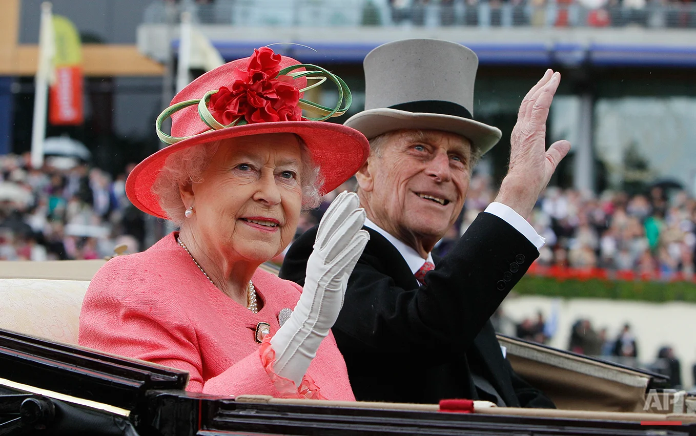Britain's Queen Elizabeth II with Prince Philip arrive by horse drawn carriage in the parade ring on the third day, traditionally known as Ladies Day, of the Royal Ascot horse race meeting at Ascot, England, Thursday, June, 16, 2011. Ascot is celebrating its 300 years of horse racing at the Royal Racecourse, that began with Britain's Queen Anne spotting an open heath suitable for racing, the first race run in August 1711, with a prize of some 100 guineas. (AP Photo/Alastair Grant)