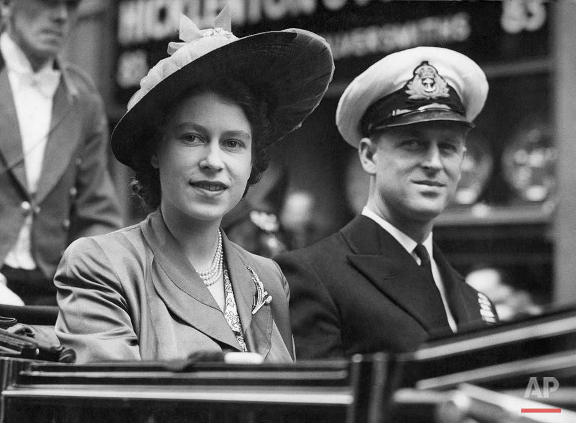 Britain's Princess Elizabeth smiles as she is seen with the Duke of Edinburgh, in an open Landau, as they drive from the Guildhall, in London, on June 8, 1948, where he was made a Freeman of the City of London. The Royal couple are going to the Mansion House for luncheon with the Lord Mayor of London. (AP Photo/Priest)