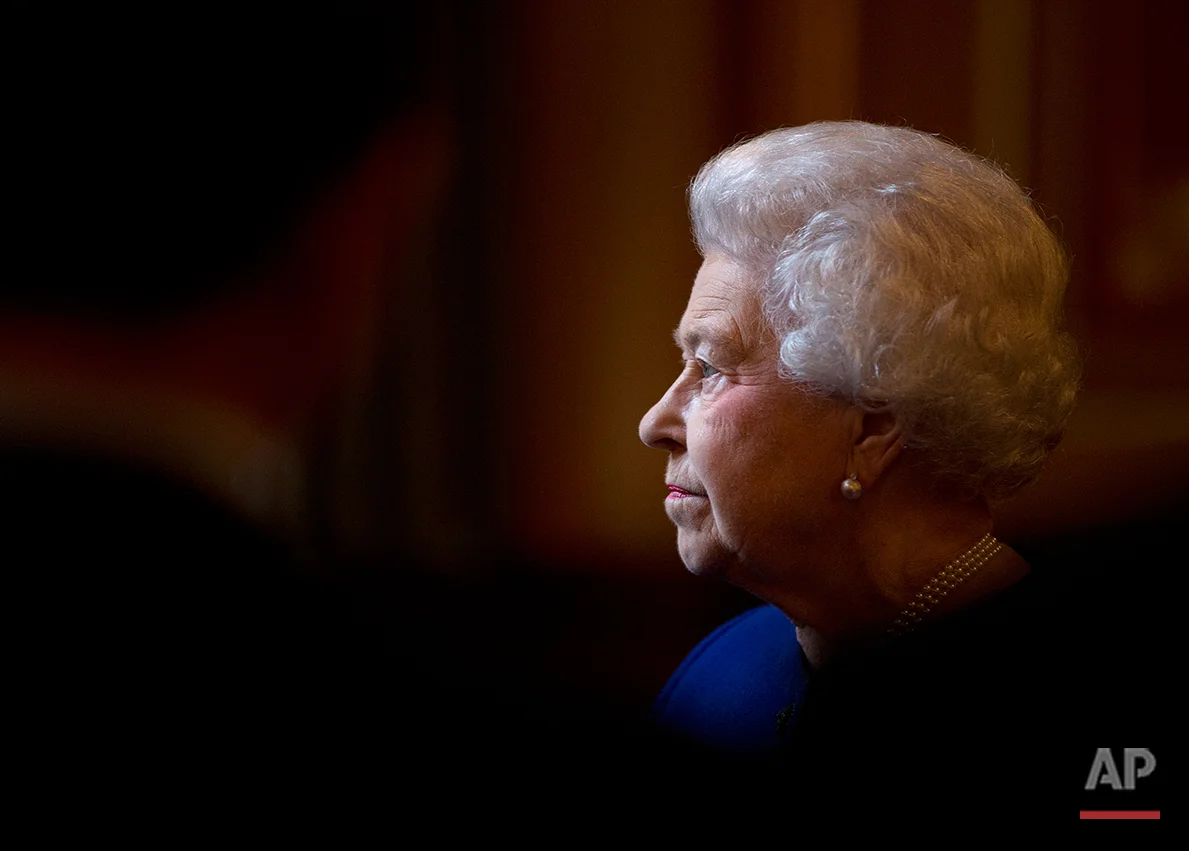 Britain's Queen Elizabeth II escorted by British Foreign Secretary William Hague, unseen, tours The Foreign and Commonwealth Office during an official visit which is part of her Jubilee celebrations in London, Tuesday, Dec. 18, 2012. (AP Photo/Alastair Grant, Pool)