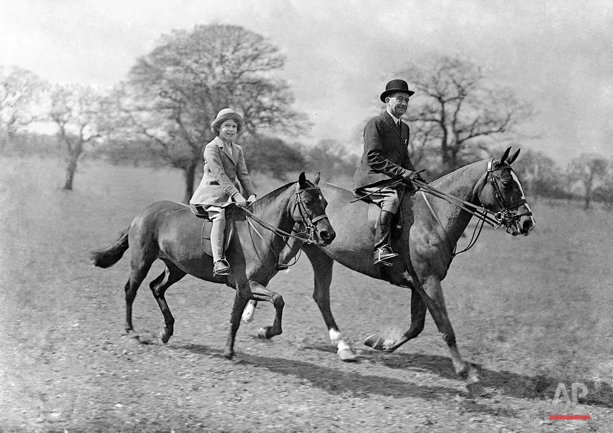 Princess Elizabeth, daughter of the Duke and Duchess of York, riding with the riding master in Windsor Great Park, Windsor, in April 1935. (AP Photo)