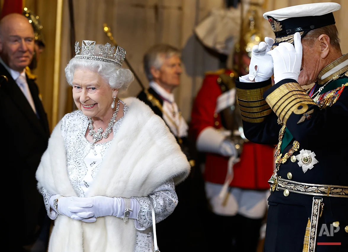 Britain's Queen Elizabeth II smiles with The Duke of Edinburgh, right, as they leave after the State Opening of Parliament, at the Houses of Parliament in London, Wednesday, May 8, 2013. The State Opening of Parliament marks the formal start of the parliamentary year, the Queen delivered a speech which set out the government's agenda for the coming year. (AP Photo/Kirsty Wigglesworth, Pool)