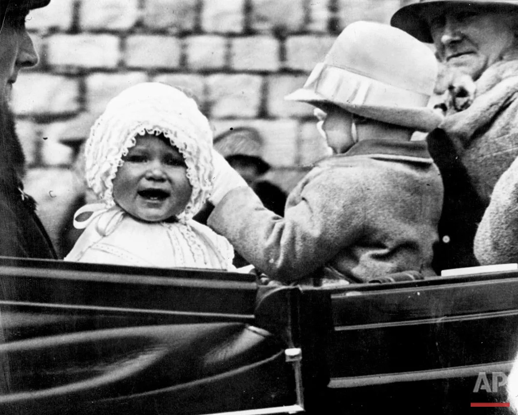 In this 1927 photo, Princess Elizabeth is taken for a ride in the grounds of Windsor Castle, with her cousin, the honourable Gerald Lascelles, right, son of Princess Royal. Britain's Queen Elizabeth celebrates her 90th birthday on Thursday, April 21, 2016. (AP Photo)