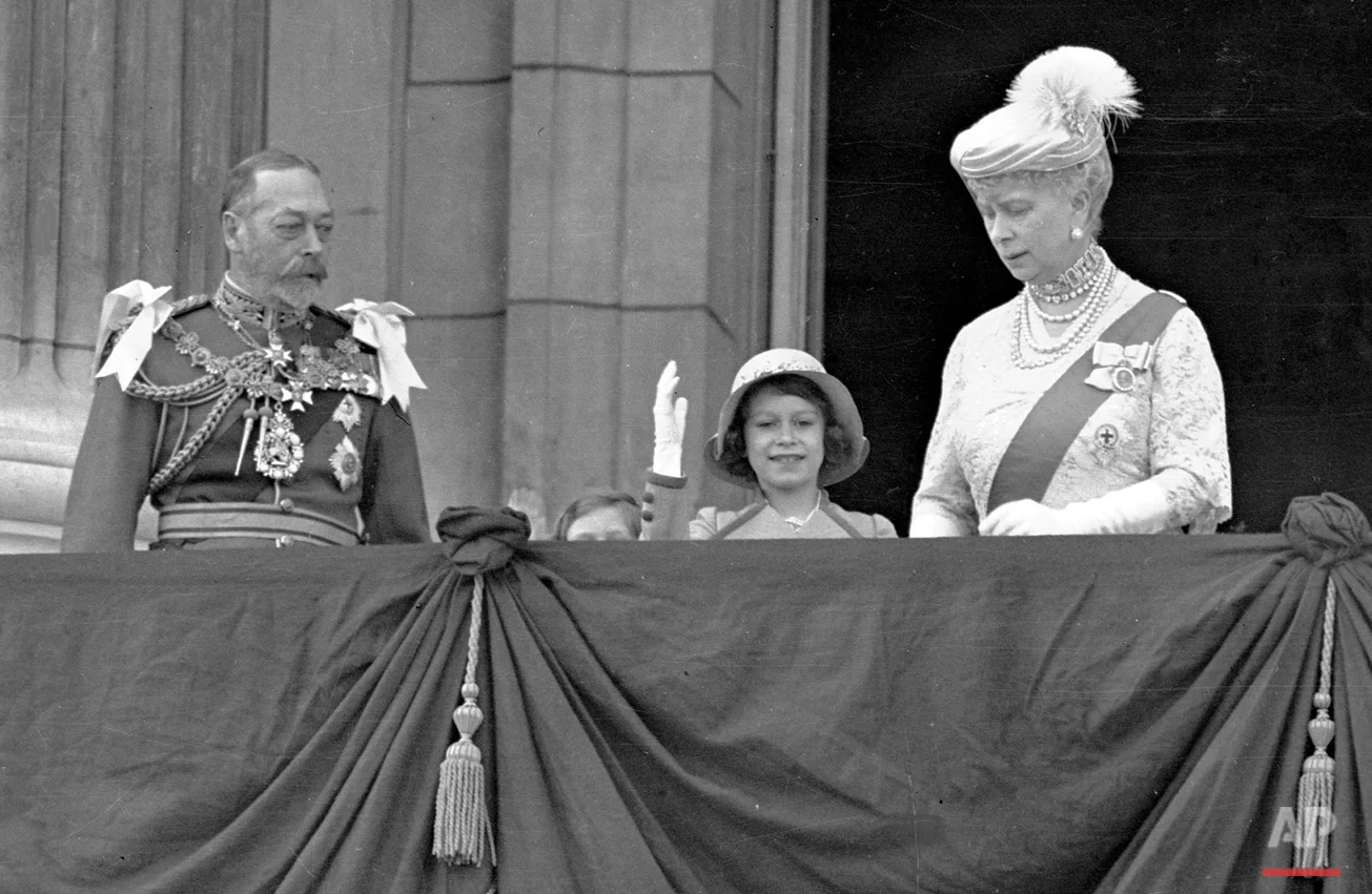 Britain's Queen Elizabeth II, then Princess Elizabeth, centre, waves as she stands on the on the balcony of Buckingham Palace, London, with her grandparents King George V and Queen Mary, in this May 6, 1935 photo. Princess Margaret is just visible over the balcony edge. The Queen will celebrate her 80th birthday on April 21, 2006. (AP Photo)