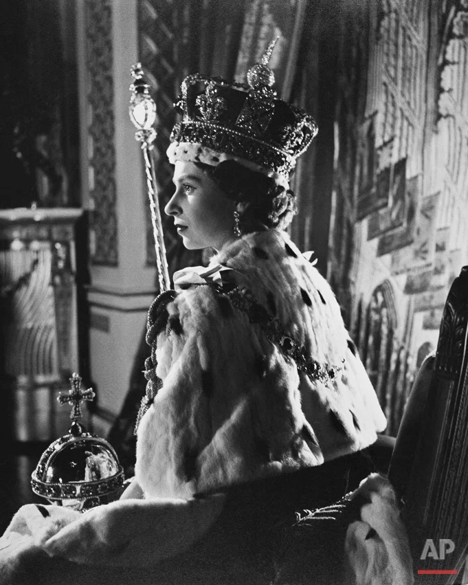 Queen Elizabeth II poses in her coronation attire in the throne room of Buckingham Palace in London, after her coronation, June 2, 1953. (AP Photo)