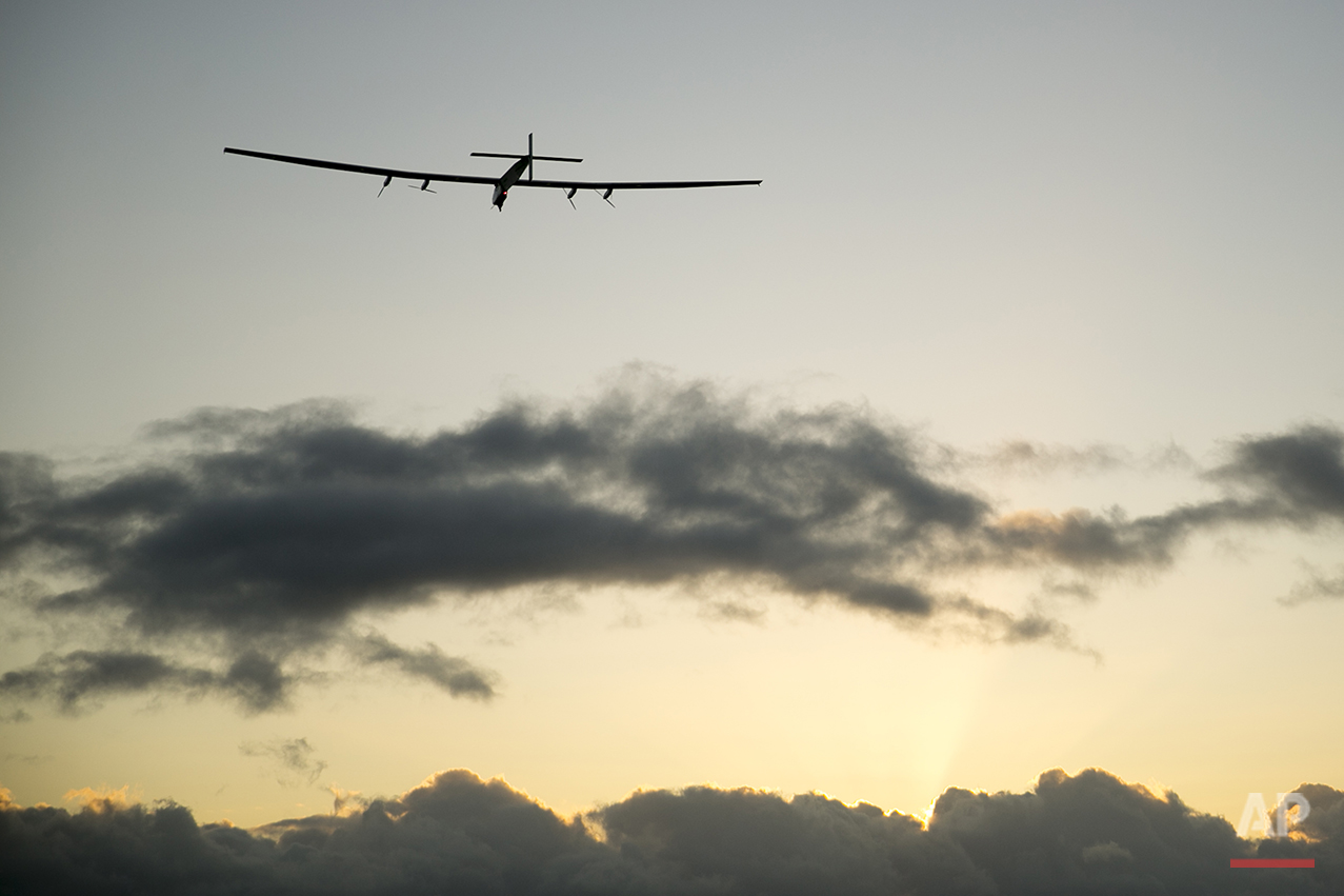  The Solar Impulse 2 solar plane flies into the sunrise out of Kalaeloa Airport, Thursday, April 21, 2016, in Kapolei, Hawaii.  The solar plane will fly a two-and-a-half day journey to Northern California.  (AP Photo/Marco Garcia) 