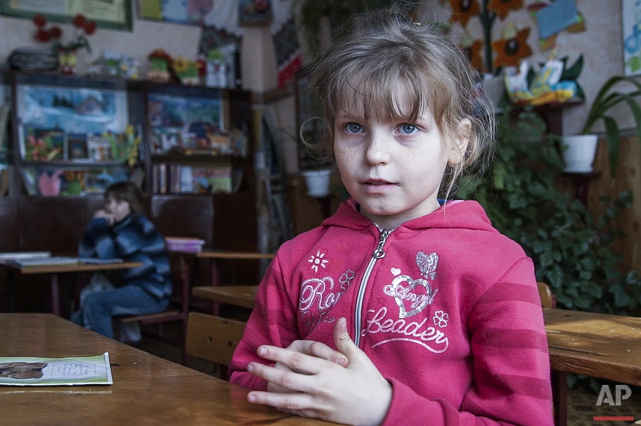  In this photo taken on Tuesday, April  5, 2016, Olesya Petrova, 9, attends lessons in a school in Zalyshany, 53 km (32 miles) southwest of the destroyed reactor of the Chernobyl plant, Ukraine. Olesya Petrova hungrily awaits the coming of warm weath