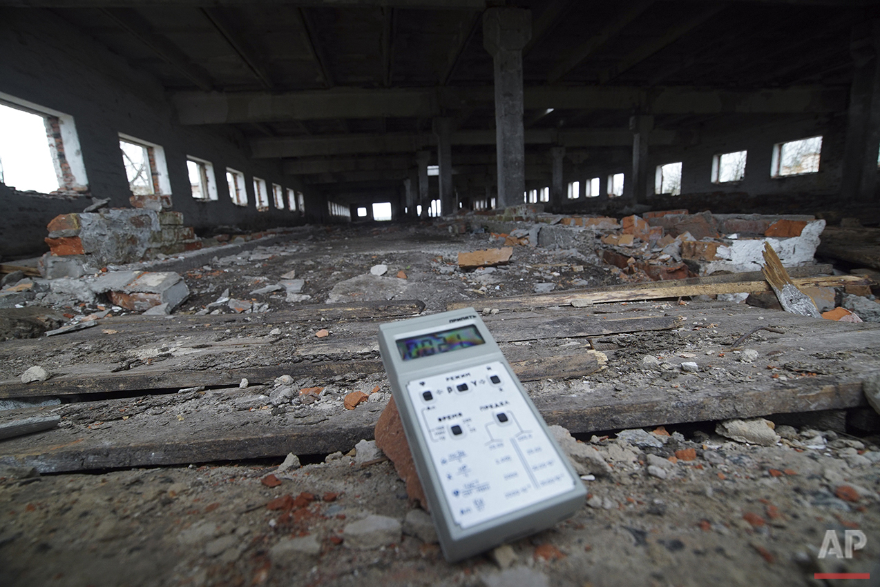  In this photo taken on Thursday, April  7, 2016, a radiation dosimeter measures radiation showing slightly increased levels in an abandoned cow farm near Zalyshany, Ukraine. After the April 26, 1986 explosion and fire spewed radioactive fallout over