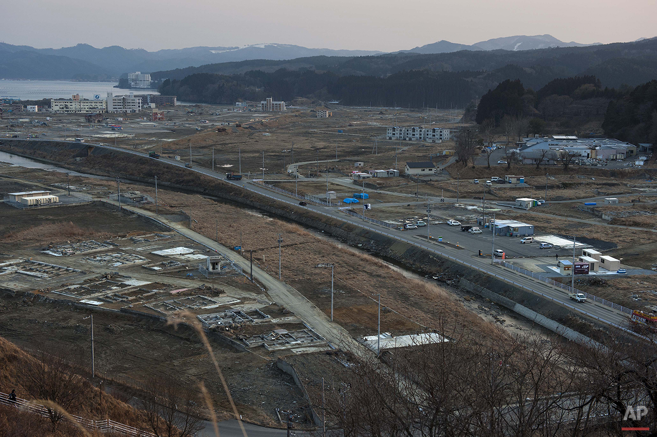  In this Feb. 23, 2012 photo, vehicles pass through the ruins of the leveled city of Minamisanriku, Miyagi Prefecture, northern Japan, almost one year after the March 11, 2011 tsunami. (AP Photo/David Guttenfelder) 
