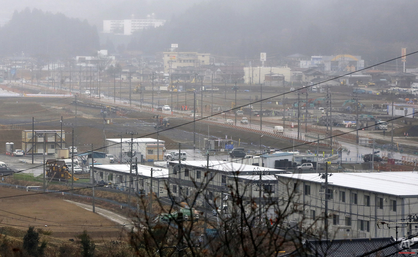  In this Sunday, March 6, 2016 photo, reconstruction process is seen at the 2011 tsunami destroyed residential neighborhood at Shishiori area in Kesennuma, Miyagi Prefecture, northeastern Japan. Five years after the disaster, construction work is cle