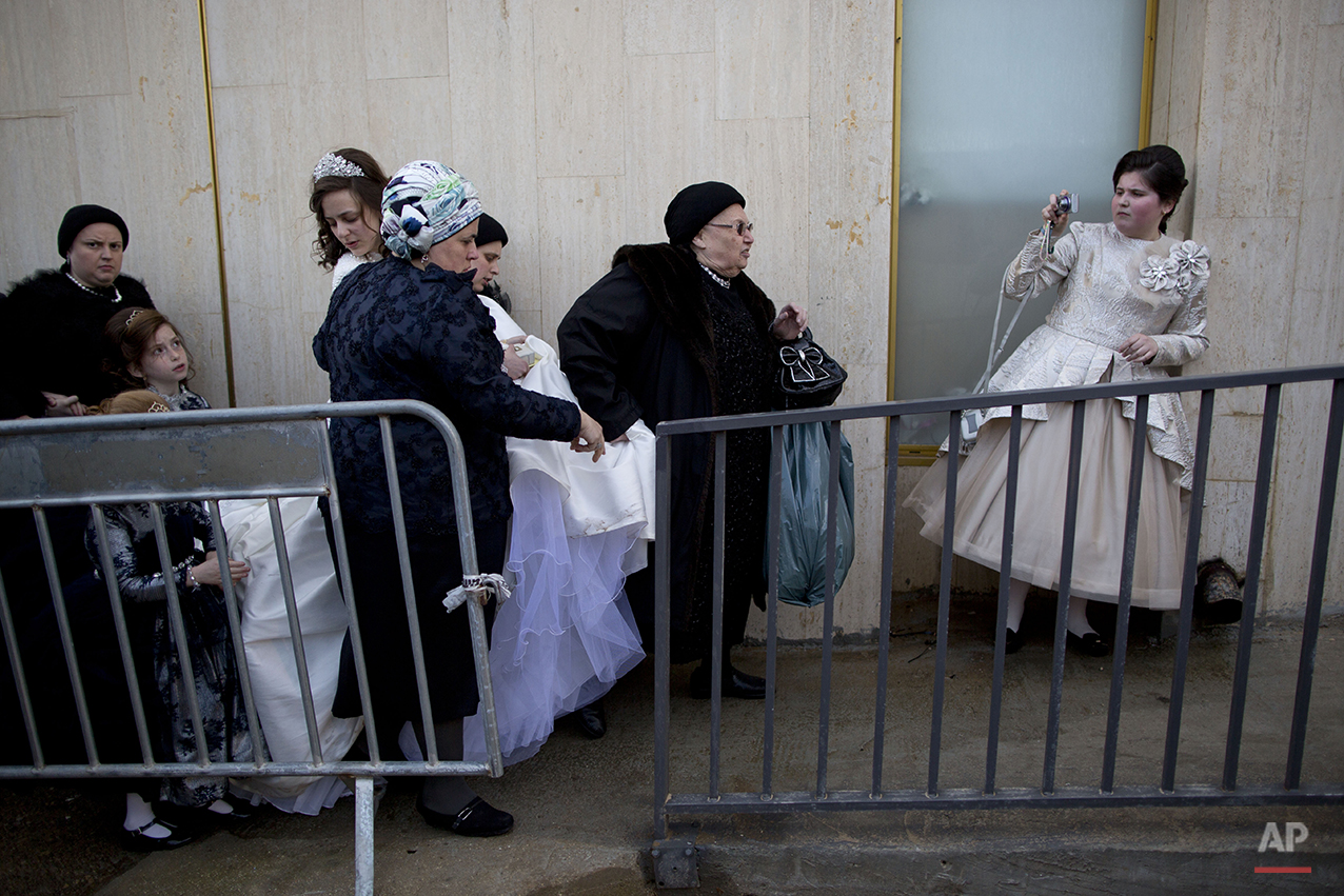  A Jewish bride arrives with family members during her wedding to the grandson of the Rabbi of the Tzanz Hasidic dynasty community, in Netanya, Israel, Tuesday, March 15, 2016. (AP Photo/Oded Balilty) 