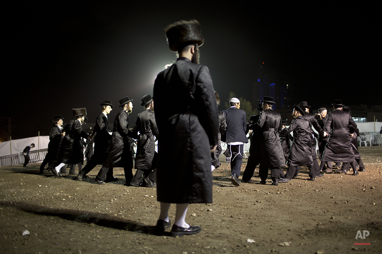  Ultra-Orthodox Jews dance in the men's section during the wedding of the grandson of the Rabbi of the Tzanz Hasidic dynasty community, in Netanya, Israel, Tuesday, March 15, 2016. (AP Photo/Oded Balilty) 