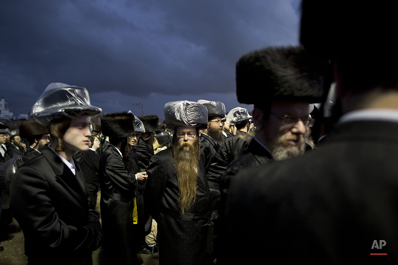  Ultra-Orthodox Jews gather in the men's section during the wedding of the grandson of the Rabbi of the Tzanz Hasidic dynasty community, in Netanya, Israel, Tuesday, March 15, 2016. (AP Photo/Oded Balilty) 