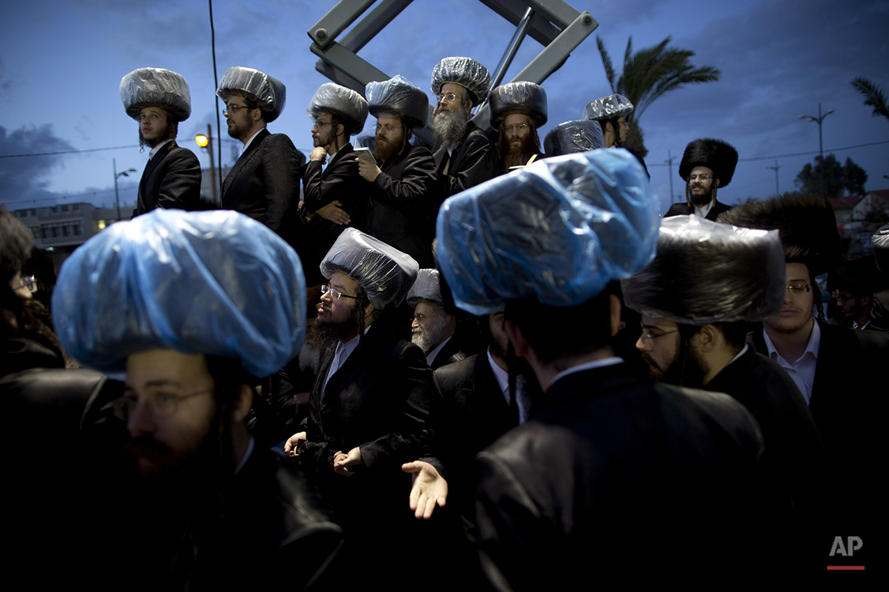  Ultra-Orthodox Jews gather in the men's section during the wedding of the grandson of the Rabbi of the Tzanz Hasidic dynasty community, in Netanya, Israel, Tuesday, March 15, 2016. (AP Photo/Oded Balilty) 