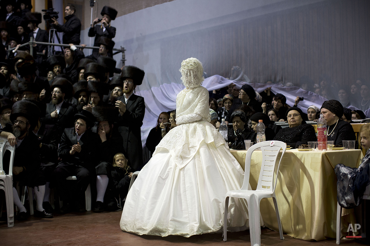 An ultra-Orthodox Jewish bride enters to the men's section of the wedd...