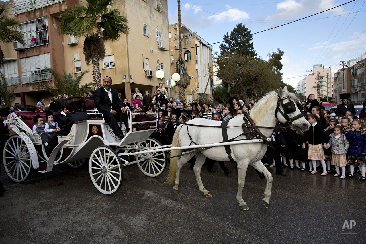  Ultra-Orthodox Jews ride a horse-drawn carriage during the wedding of the grandson of the Rabbi of the Tzanz Hasidic dynasty community, in Netanya, Israel, Tuesday, March 15, 2016. (AP Photo/Oded Balilty) 