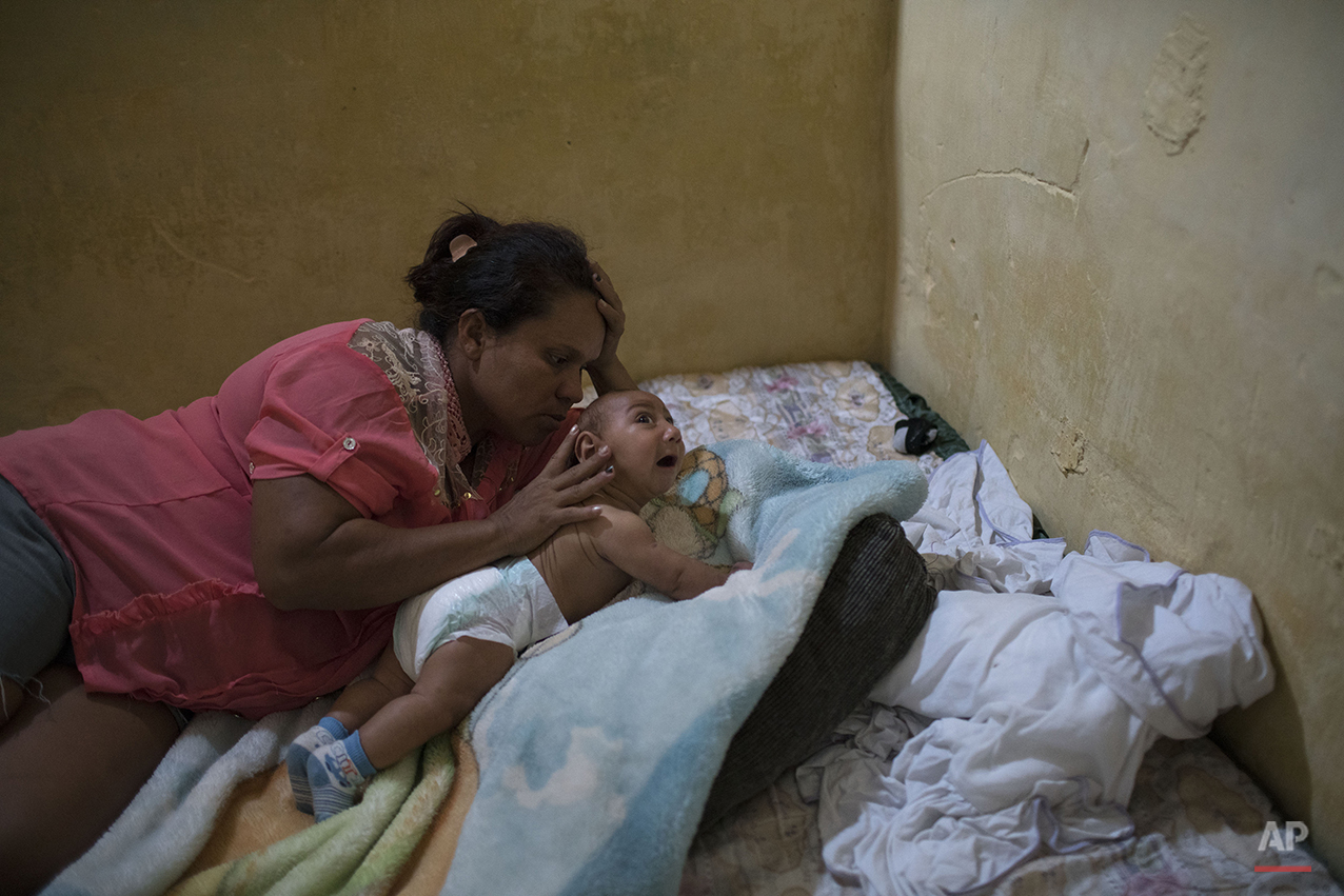  In this Jan. 30, 2016 photo, Solange Ferreira tries to make her son Jose Wesley sleep, in Bonito, Pernambuco state, Brazil. We were lucky to learn about the bucket,” said Ferreira. (AP Photo/Felipe Dana) 