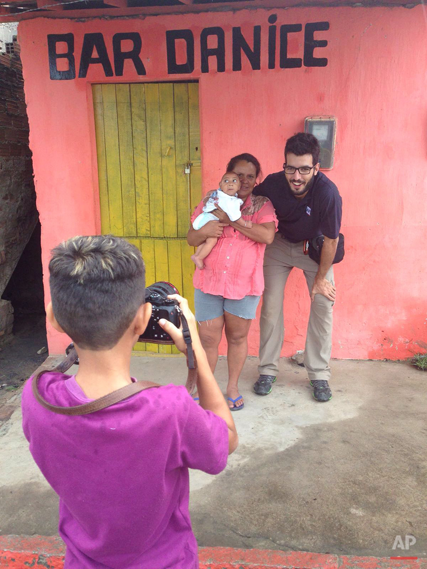  In this  Jan. 30, 2016 photo, Associated Press photographer Felipe Dana poses for a photo with Solange Ferreira holding her son Jose Wesley, who suffers from microcephaly, a kind of brain deformity in babies, in Bonito, Pernambuco state, Brazil, as 