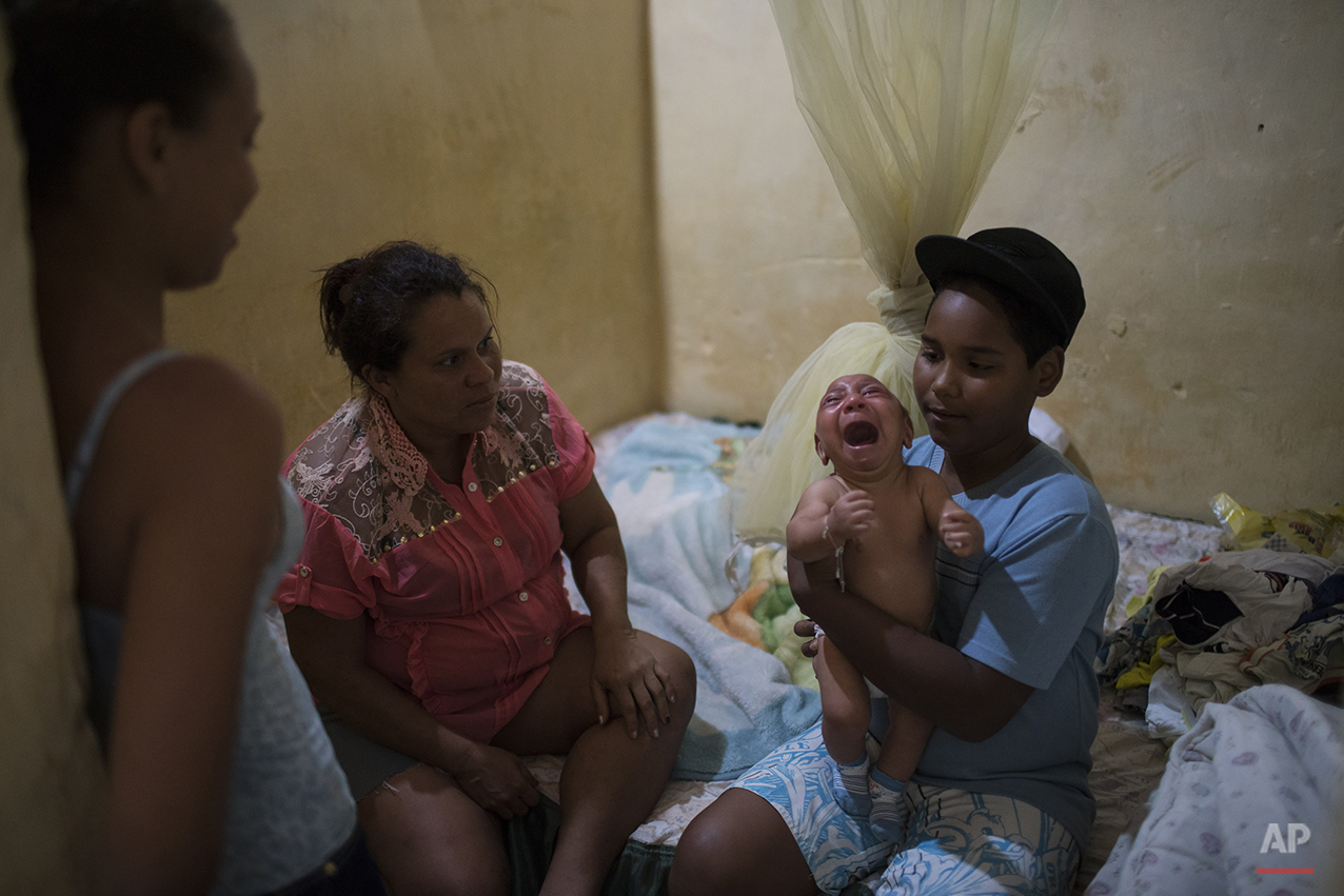  In this Jan. 30, 2016 photo, Solange Ferreira, left, watches as her nephew Jhonnata tries to calm Jose Wesley, in their house in Bonito, Pernambuco state, Brazil. According to Ferreira when his screaming gets bad nobody in the house can stand it. On