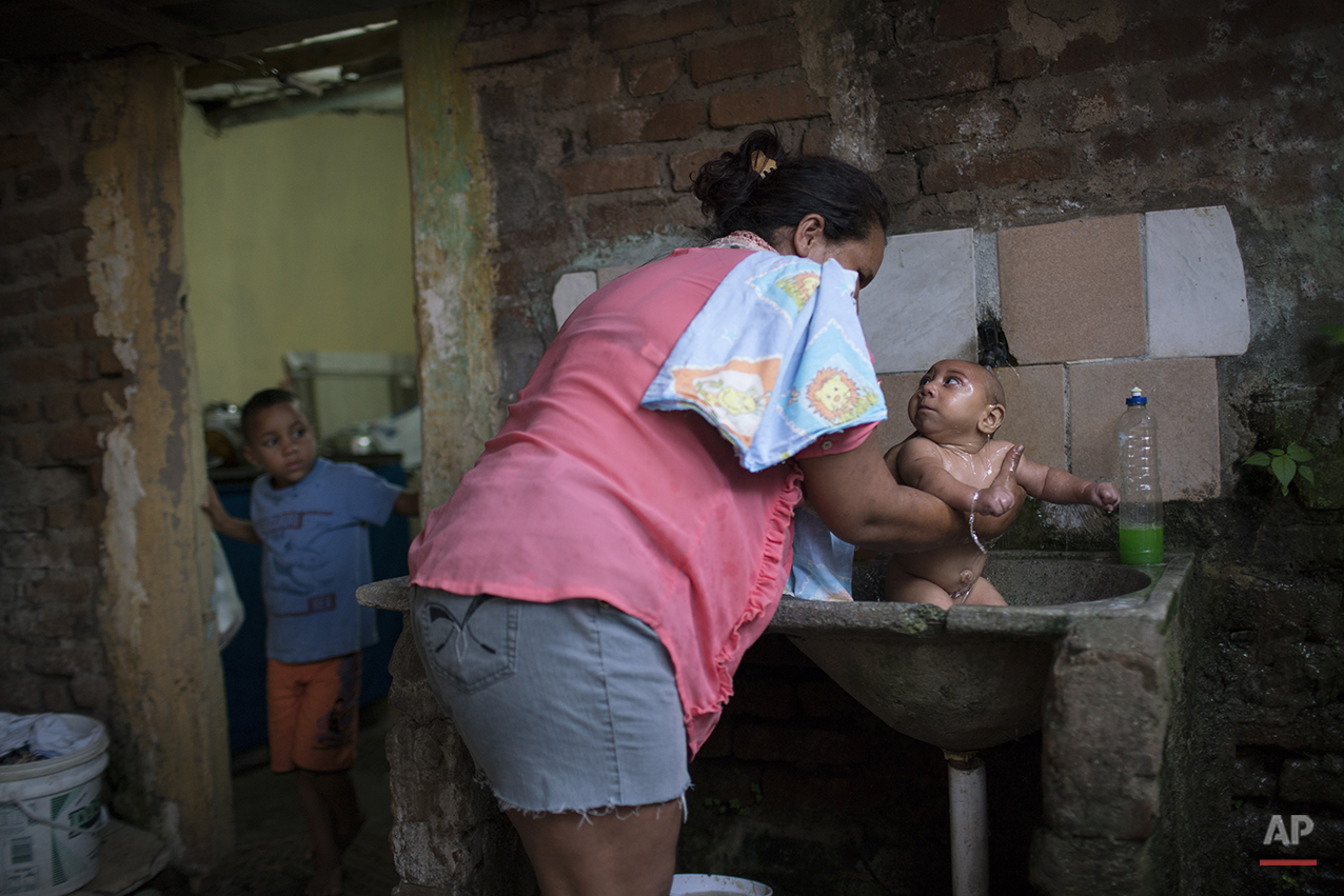  In this Jan. 30, 2016 photo, Solange Ferreira bathes Jose Wesley in a sink in their house in Bonito, Pernambuco state, Brazil. The town of Bonito is no different than others in terms of mosquitoes and the viruses they transmit, such as Zika, dengue 