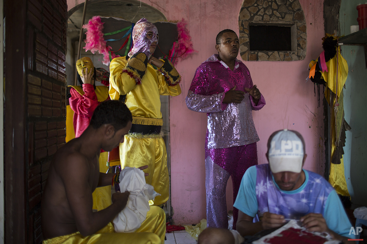  "Caretas" performers put on their hand-made costumes before parading at Carnival festivities in Triunfo, Brazil, Monday, Feb. 8, 2016. This town's carnival is far from the glitz and glamour of Rio de Janeiro's famous Sambadrome parades. (AP Photo/Fe