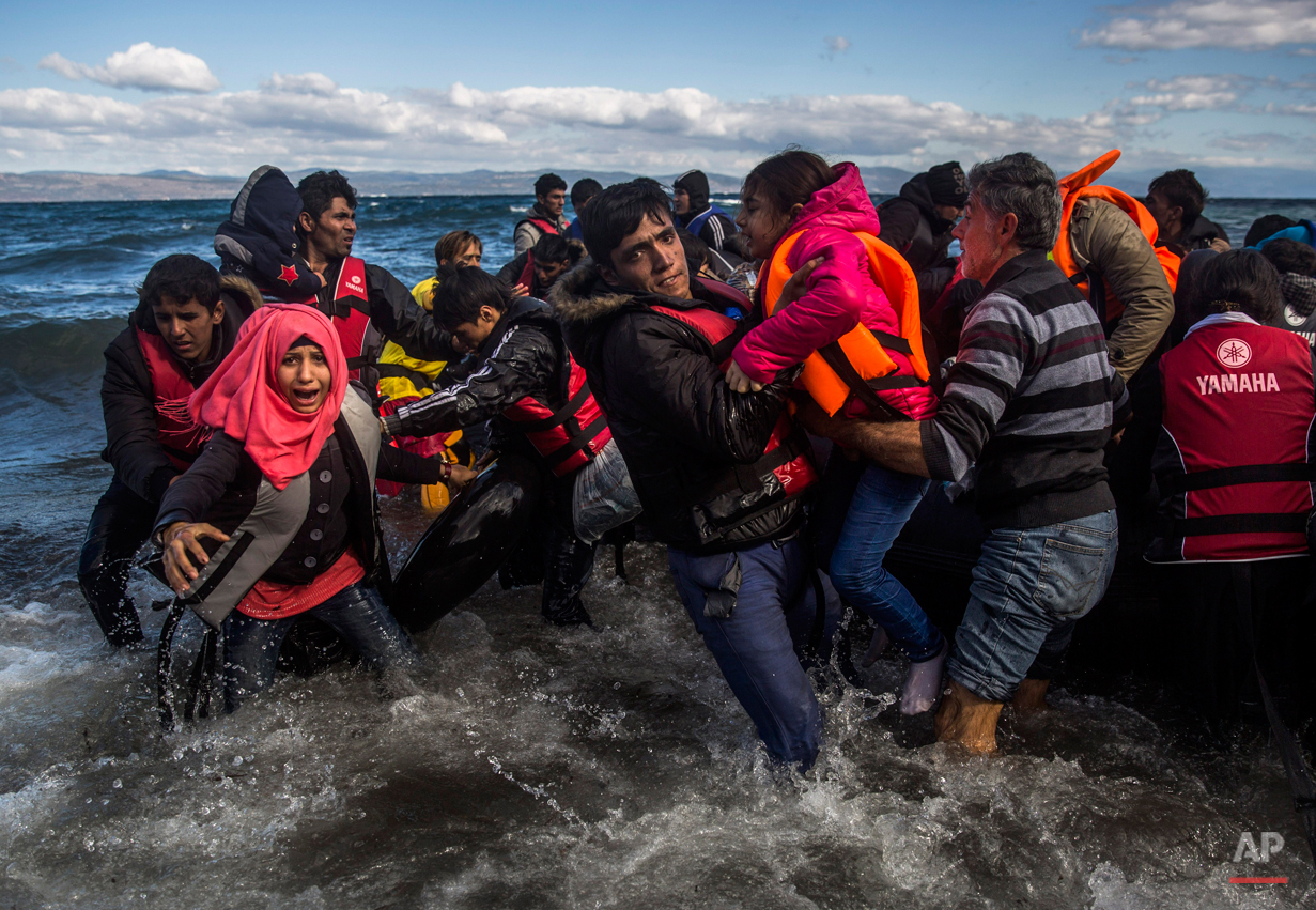  Afghan migrants disembark safely from their frail boat in bad weather on the Greek island of Lesbos after crossing the Aegean see from Turkey, Wednesday, Oct. 28, 2015. Greece's government says it is preparing a rent-assistance program to cope with 