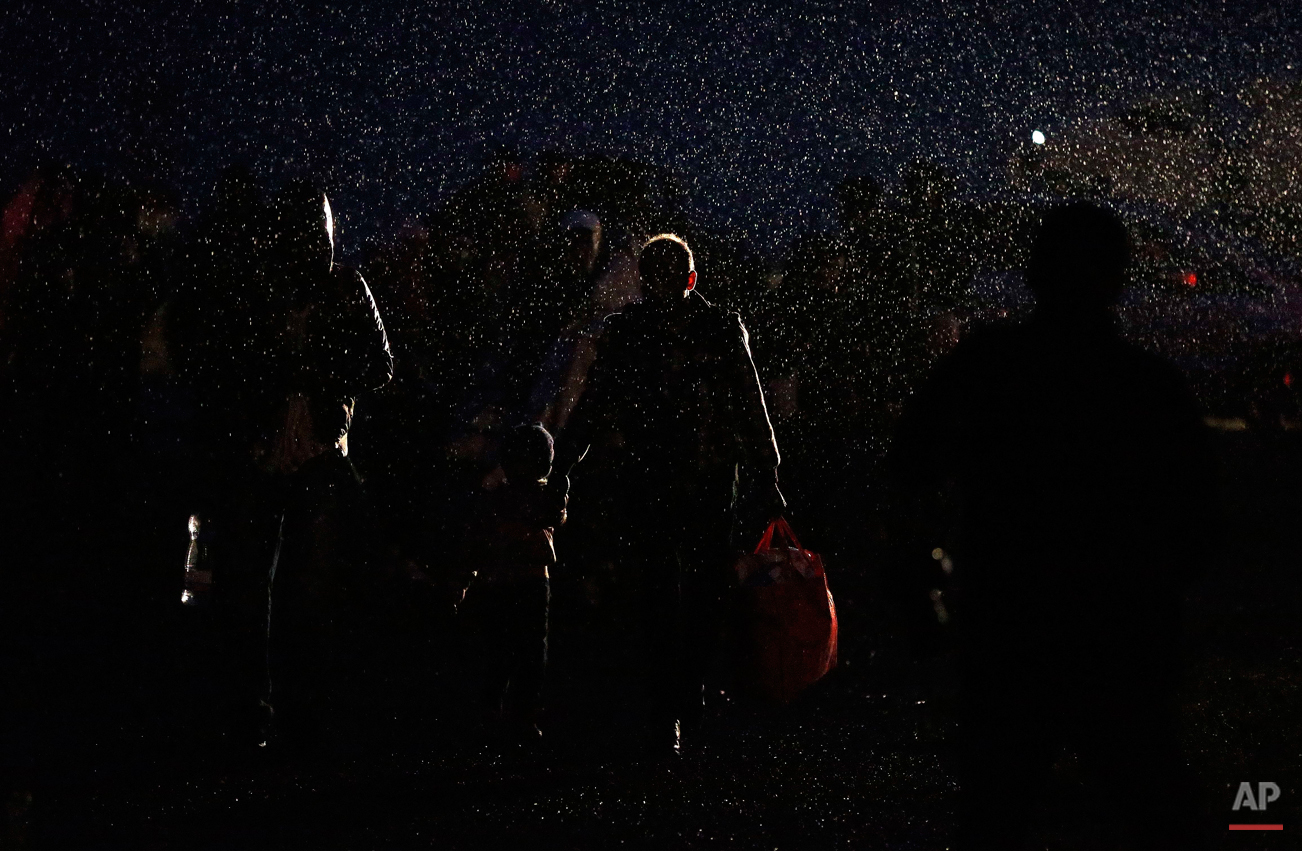  Migrants arrive during heavy rain at the Hungarian-Austrian border in Nickelsdorf,  Austria, Saturday, Sept. 5, 2015, where they came from Budapest as Austria in the early-morning hours said it and Germany would let them in.  (AP Photo/Frank Augstei