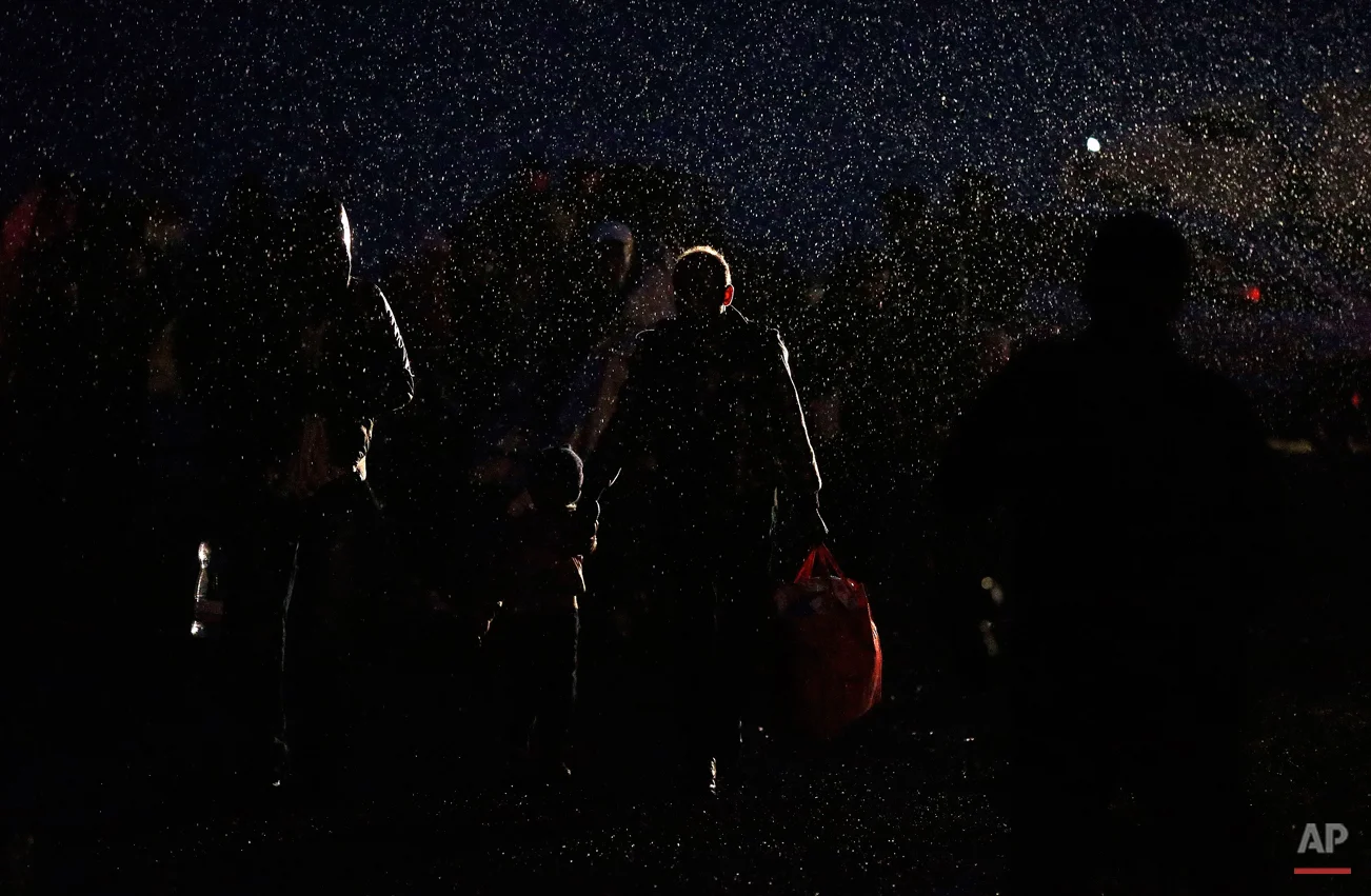 Migrants arrive during heavy rain at the Hungarian-Austrian border in Nickelsdorf, Austria, Saturday, Sept. 5, 2015, where they came from Budapest as Austria in the early-morning hours said it and Germany would let them in. (AP Photo/Frank Augstein)