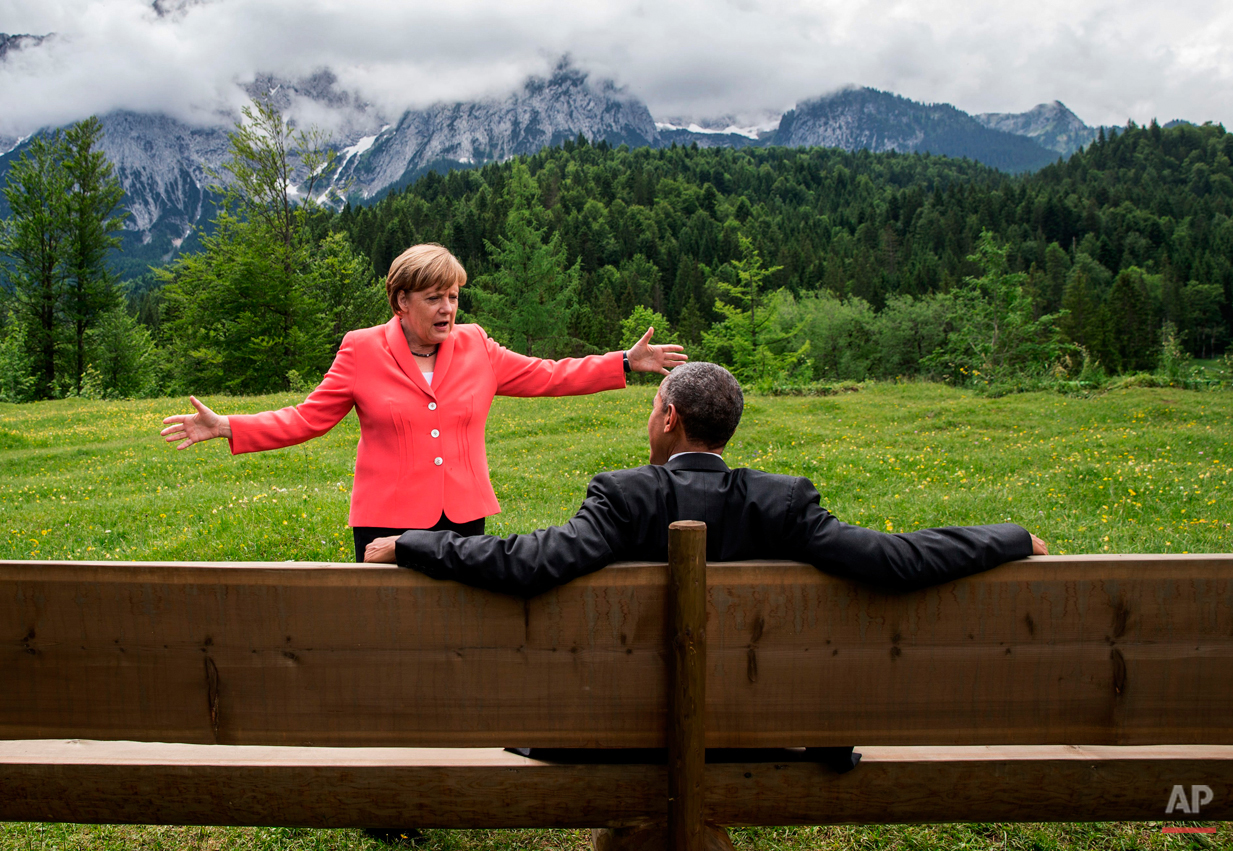  German chancellor Angela Merkel  speaks with U.S. president Barack Obama at  Schloss Elmau hotel near Garmisch-Partenkirchen, southern Germany, Monday June 8, 2015 during the G-7 summit.  (Michaek Kappeler/Pool Photo via AP) 