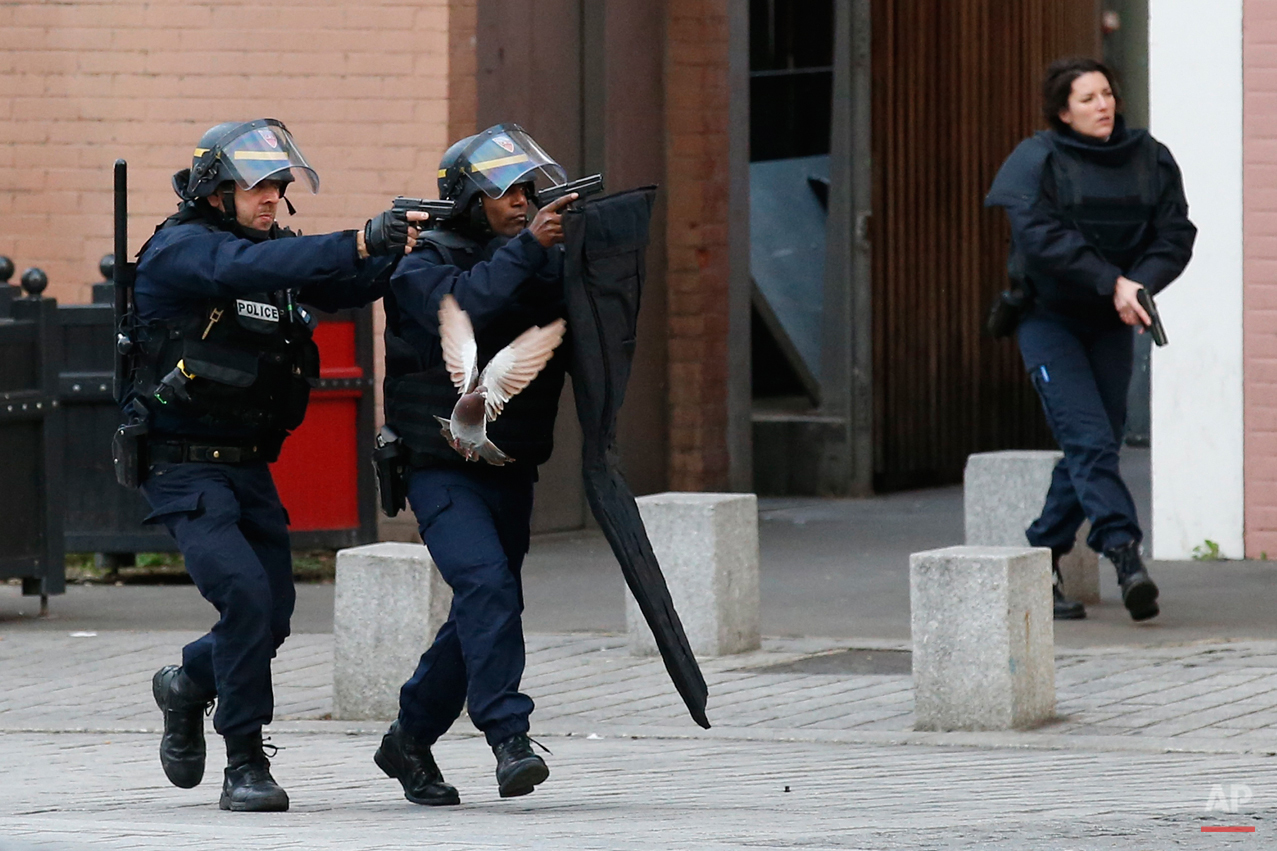  Police forces operate in Saint-Denis, a northern suburb of Paris, Wednesday, Nov. 18, 2015. Police say two suspects in last week's Paris attacks, a man and a woman, have been killed in a police operation north of the capital. Two police officers hav