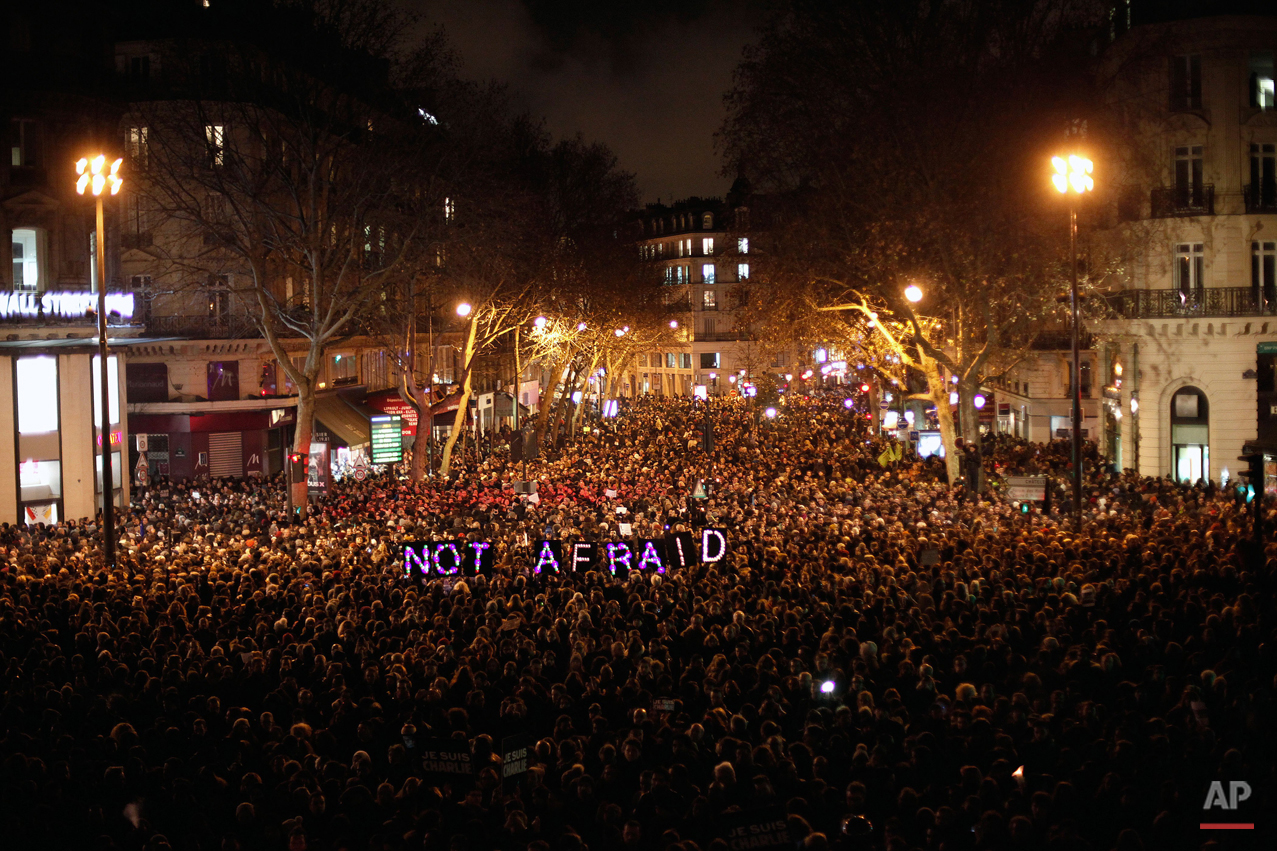  People gather to pay respect for the victims of a terror attack against satirical newspaper Charlie Hebdo, in Paris, Wednesday, Jan. 7, 2015. (AP Photo/Thibault Camus) 