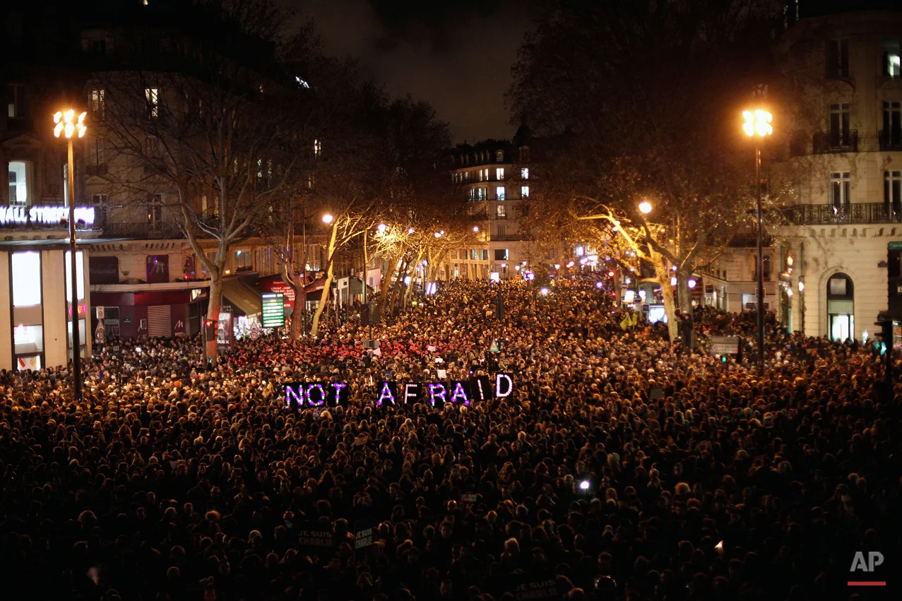 People gather to pay respect for the victims of a terror attack against satirical newspaper Charlie Hebdo, in Paris, Wednesday, Jan. 7, 2015. (AP Photo/Thibault Camus)