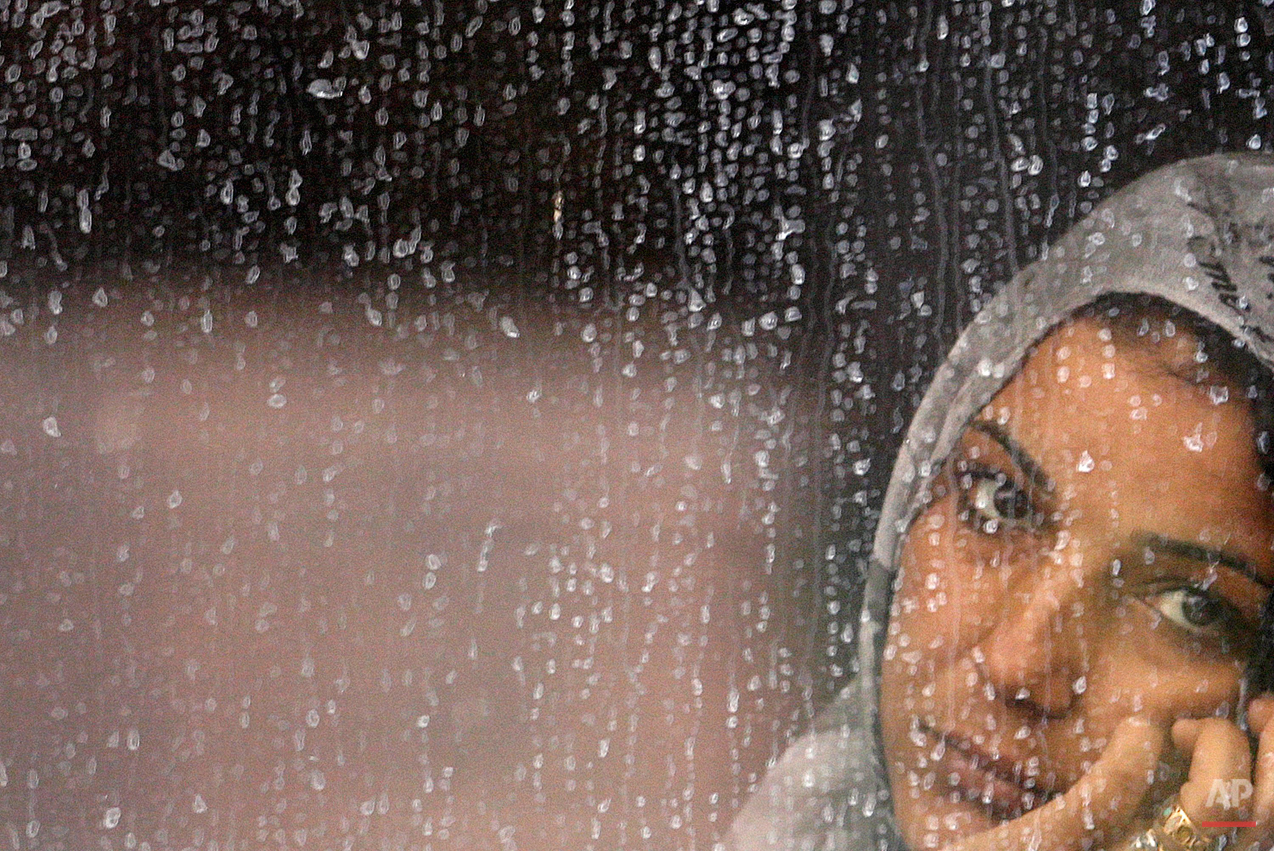  A woman rests on a train that was stopped in Bicske, Hungary, Thursday, Sept. 3, 2015. Over 150,000 migrants have reached Hungary this year, most coming through the southern border with Serbia. Many apply for asylum but quickly try to leave for rich