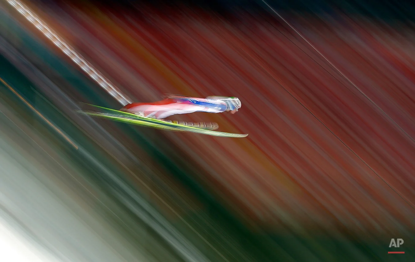 In this Feb. 22, 2015 photo, taken with slow shutter speed Norway's Rune Velta jumps during the Mixed Team Ski Jumping competition at the Nordic Skiing World Championships in Falun, Sweden, Sunday, Feb. 22, 2015. (AP Photo/Matthias Schrader)